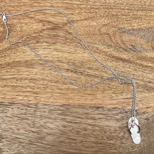 Pretty, delicate white gold necklace with flip flop with small ruby stone.